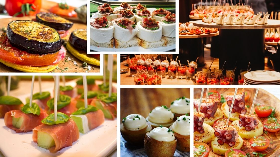 Billedet viser et udvalg af farverige og lækre tapas – små, kreative anretninger med alt fra grillede grøntsager og ost til skinke, skaldyr og mousse. Perfekt som let og elegant mad til reception, firmafest eller hyggelige sammenkomster.